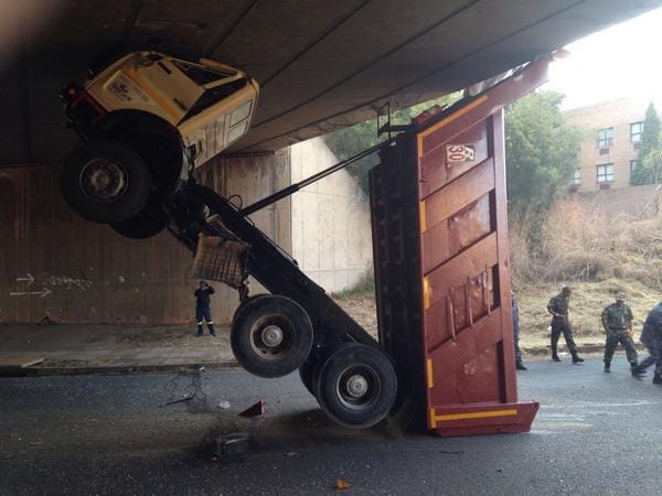 Tipper truck bin colliding with bridge
